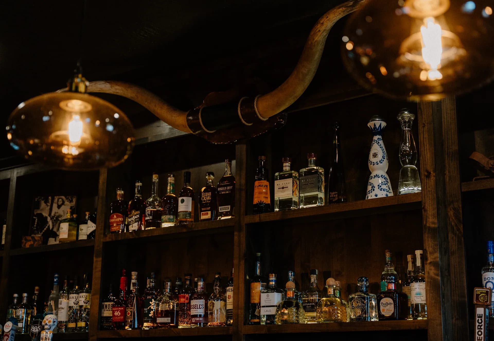 SPUR back bar with longhorn horns and amber lighting