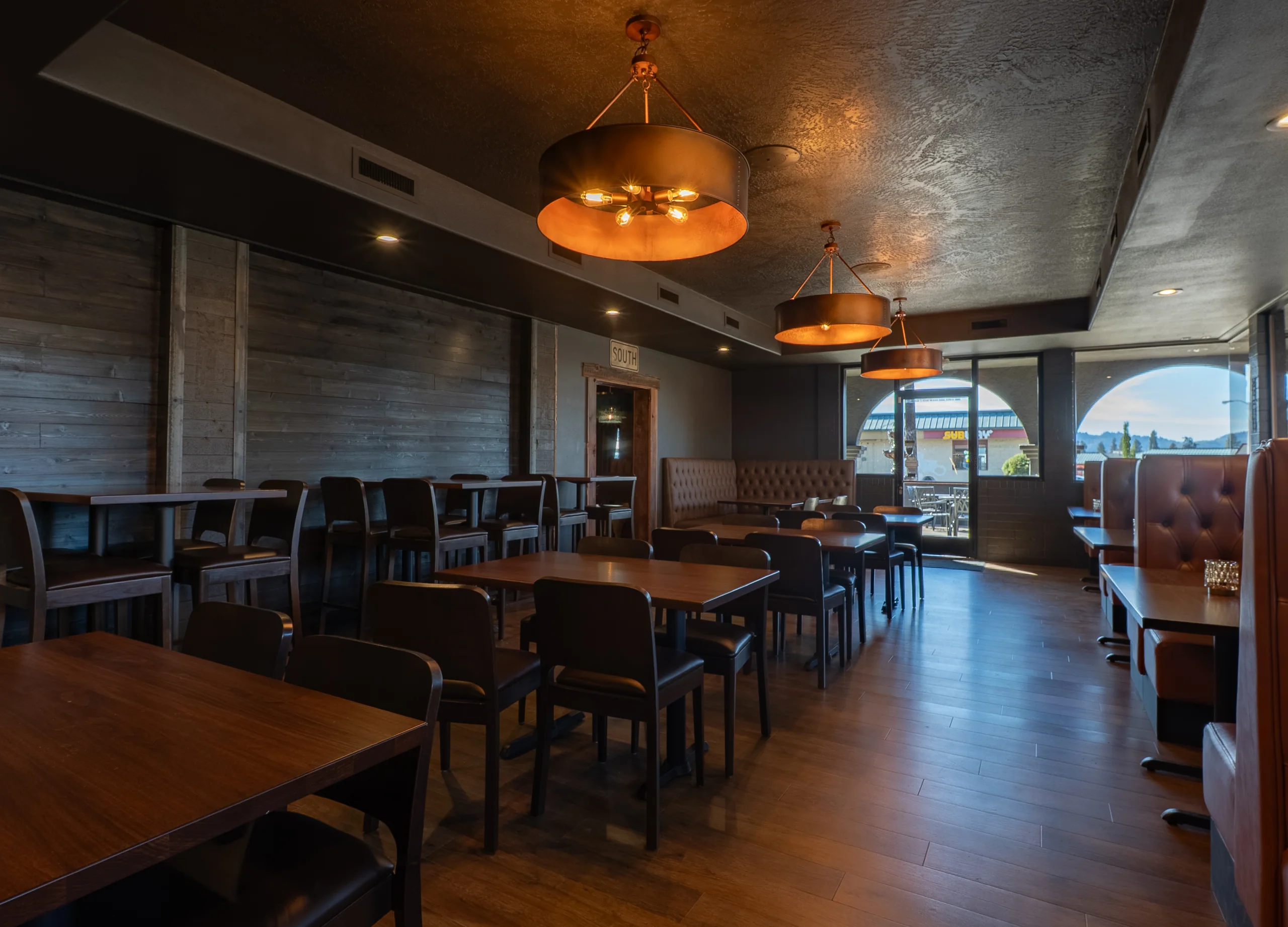 SPUR dining room with warm pendant lighting and booth seating
